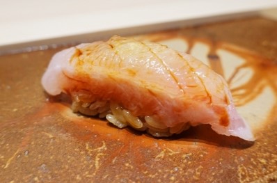 A photo of Coral hind (Yukatahata) Nigiri sushi