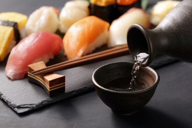 a photo of nigiri and sake