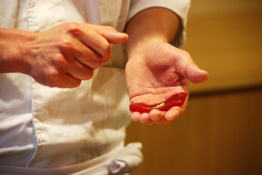 The sushi master is making sushi.